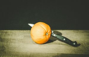 knife cutting orange for screening candidates