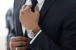 man straightening tie for a good fit