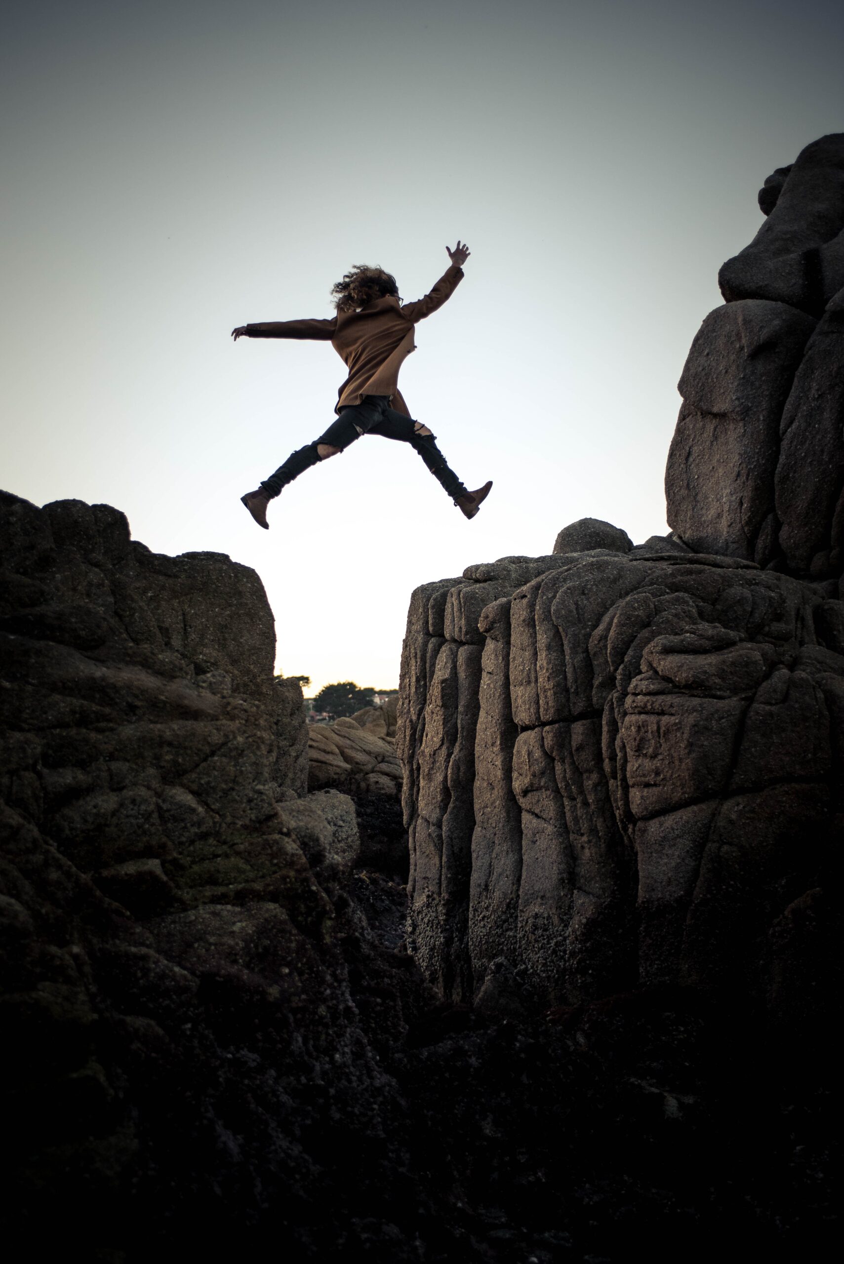 woman jumping between rocks for job hopping